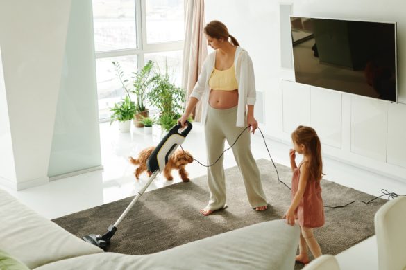 a woman and her daughter cleaning a carpet