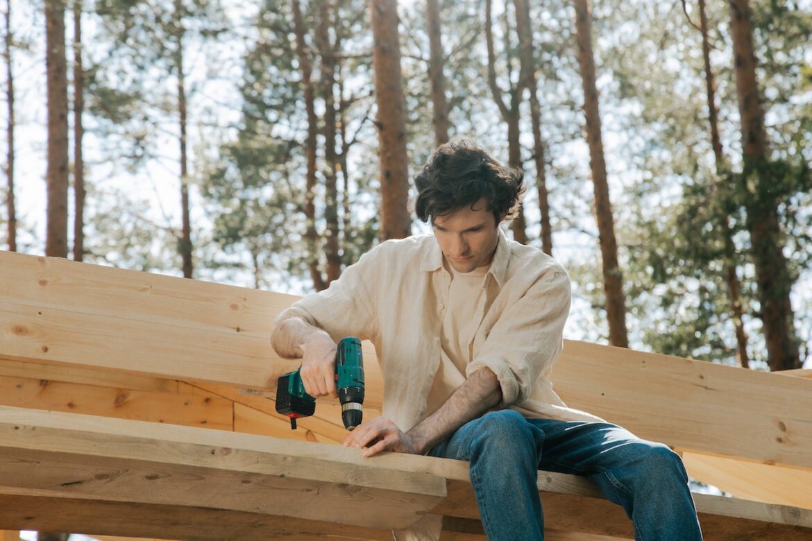a man working on a gazebo’s roof diy projects