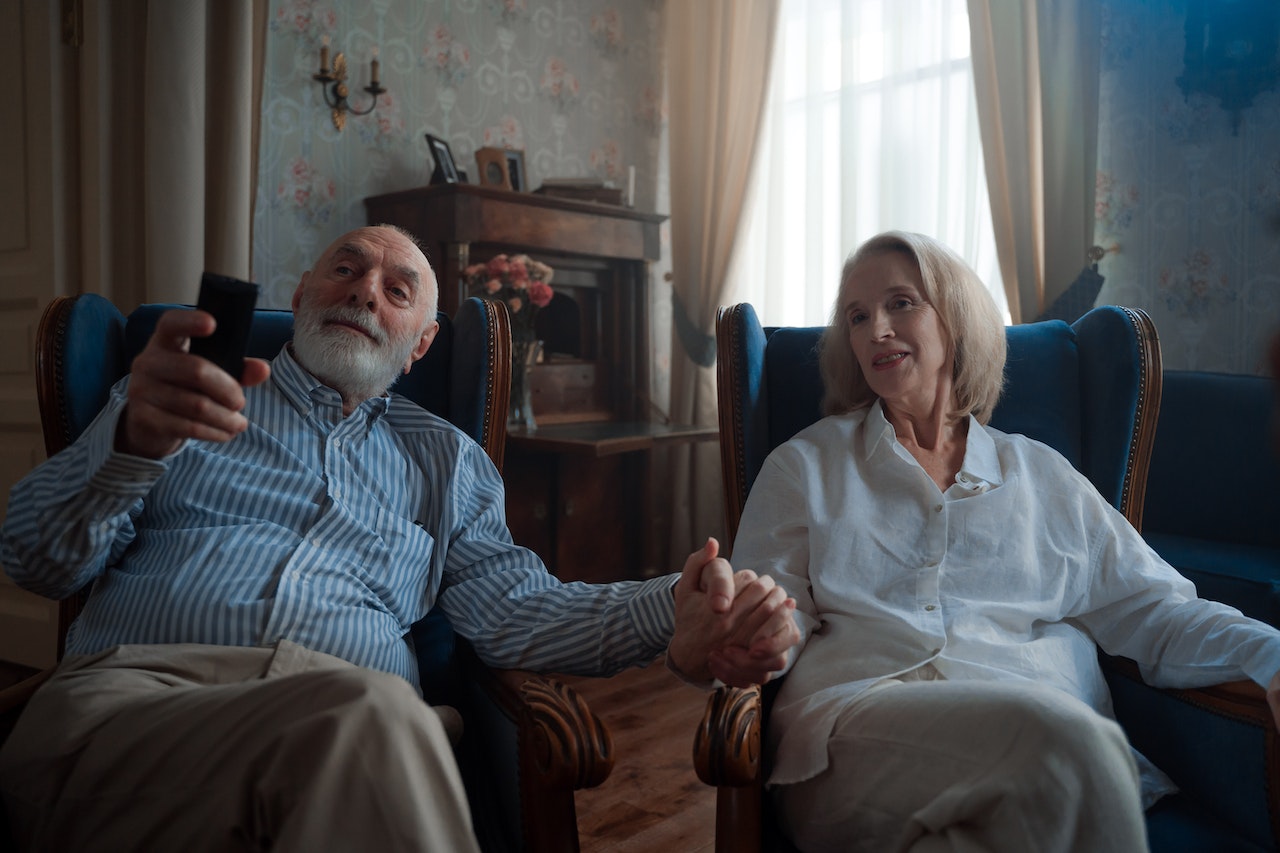 an elderly couple watching 32-inch tv