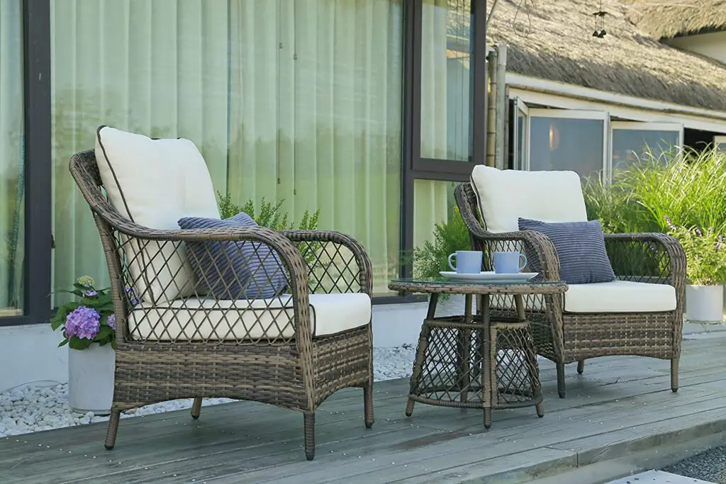 a set of rattan chairs in a farmhouse patio