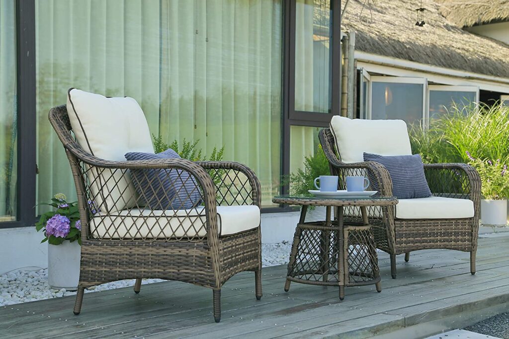 a set of rattan chairs in a farmhouse patio