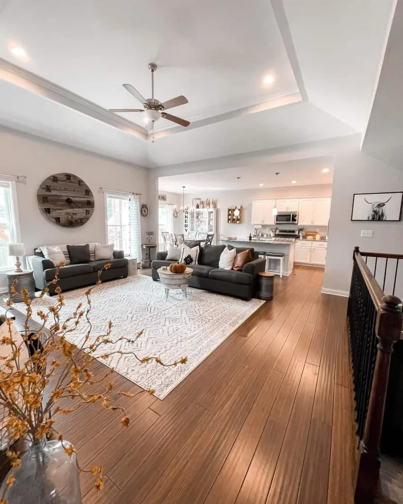 An Elegant Family Room with Wooden Clock, Brown Sofas, and a White Rug