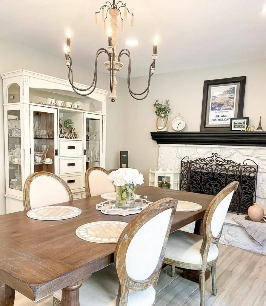 Dining Room Sophistication: Enhanced by a White Stone Fireplace