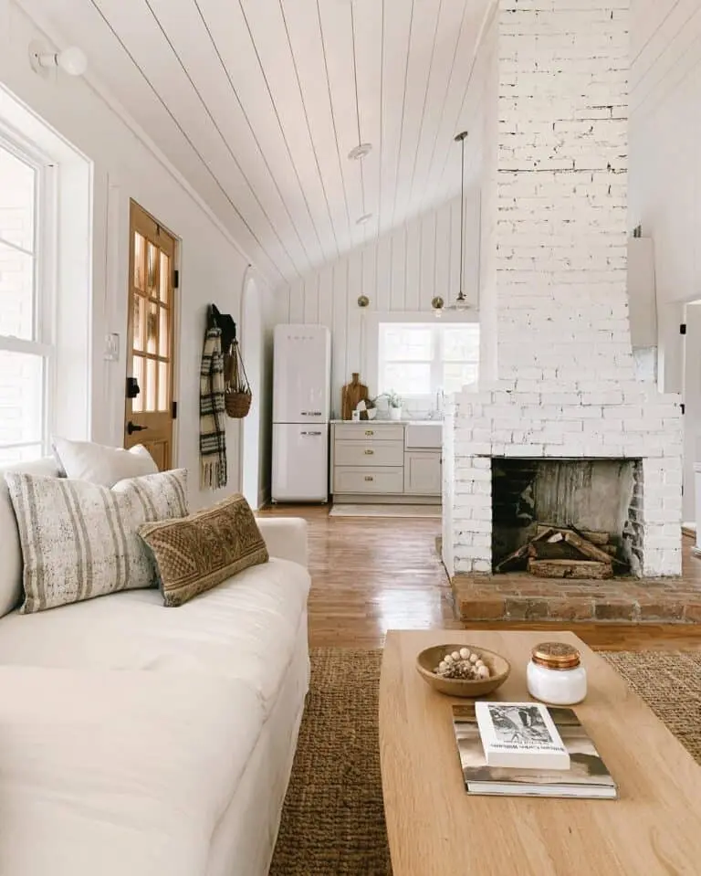 Elevate Your Space with a White Painted Brick Floor-to-Ceiling Fireplace