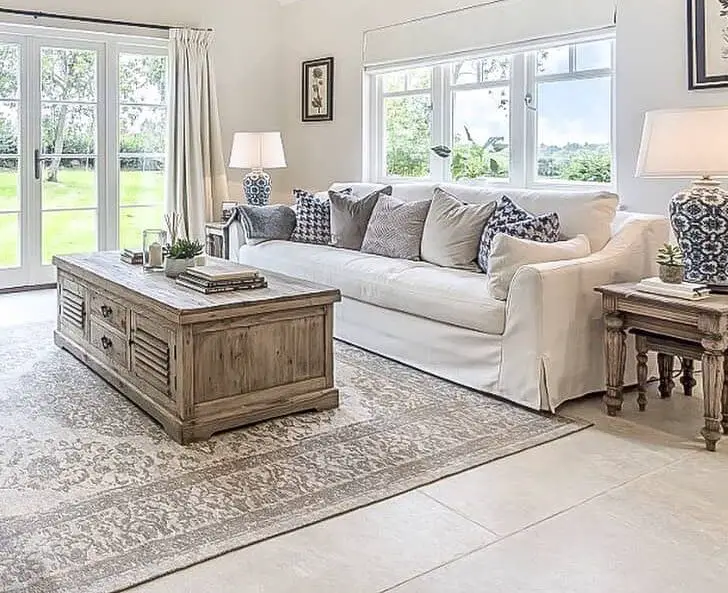 An Open Farmhouse Living Room With Ivory Rug