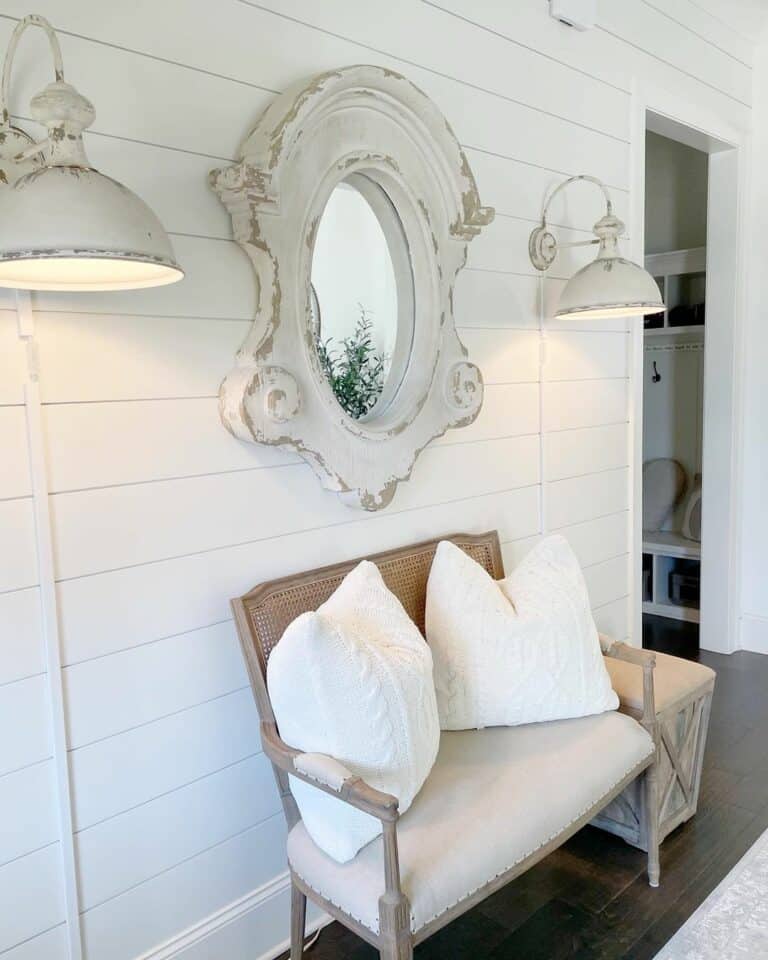 Serene Seating: Neutral Padded Bench and Vintage Wall Accents