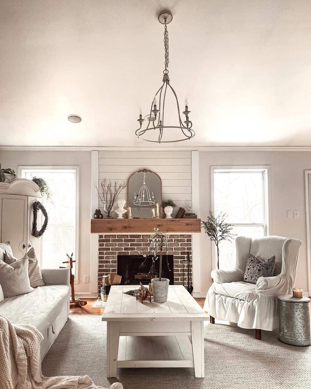 Charming White Farmhouse Living Room with Brick Fireplace