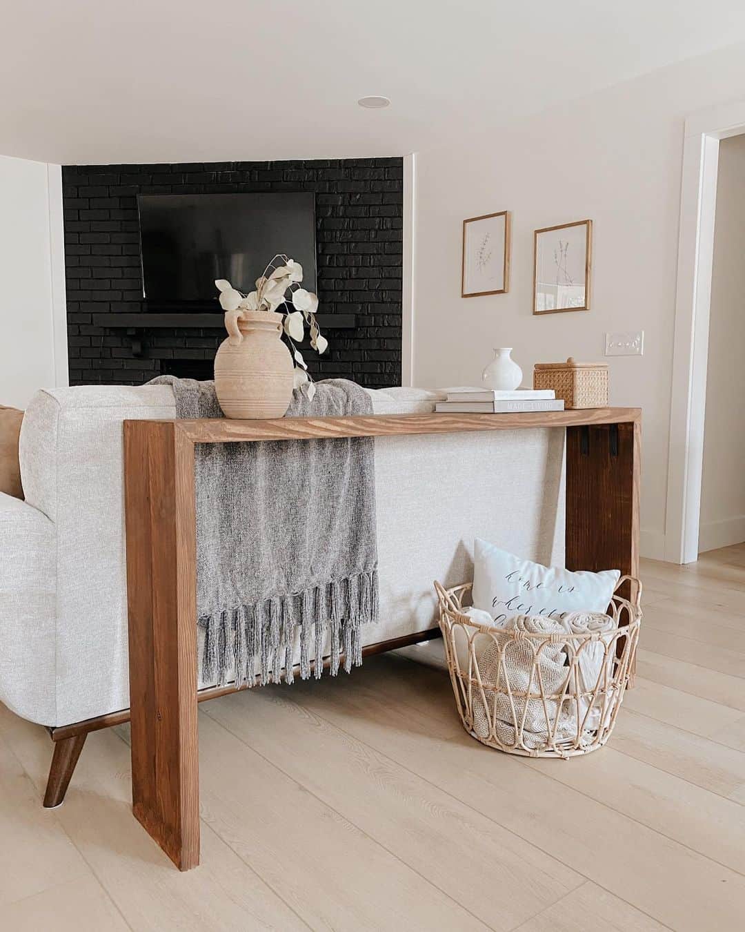 Chic Living Room Design: Wood Console Table and Striking Brick Feature Wall