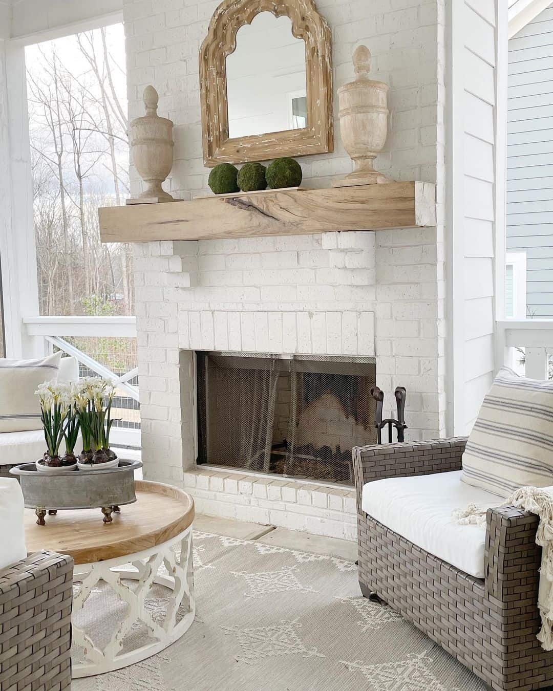 Chic Sunroom with Striking Fireplace Surround