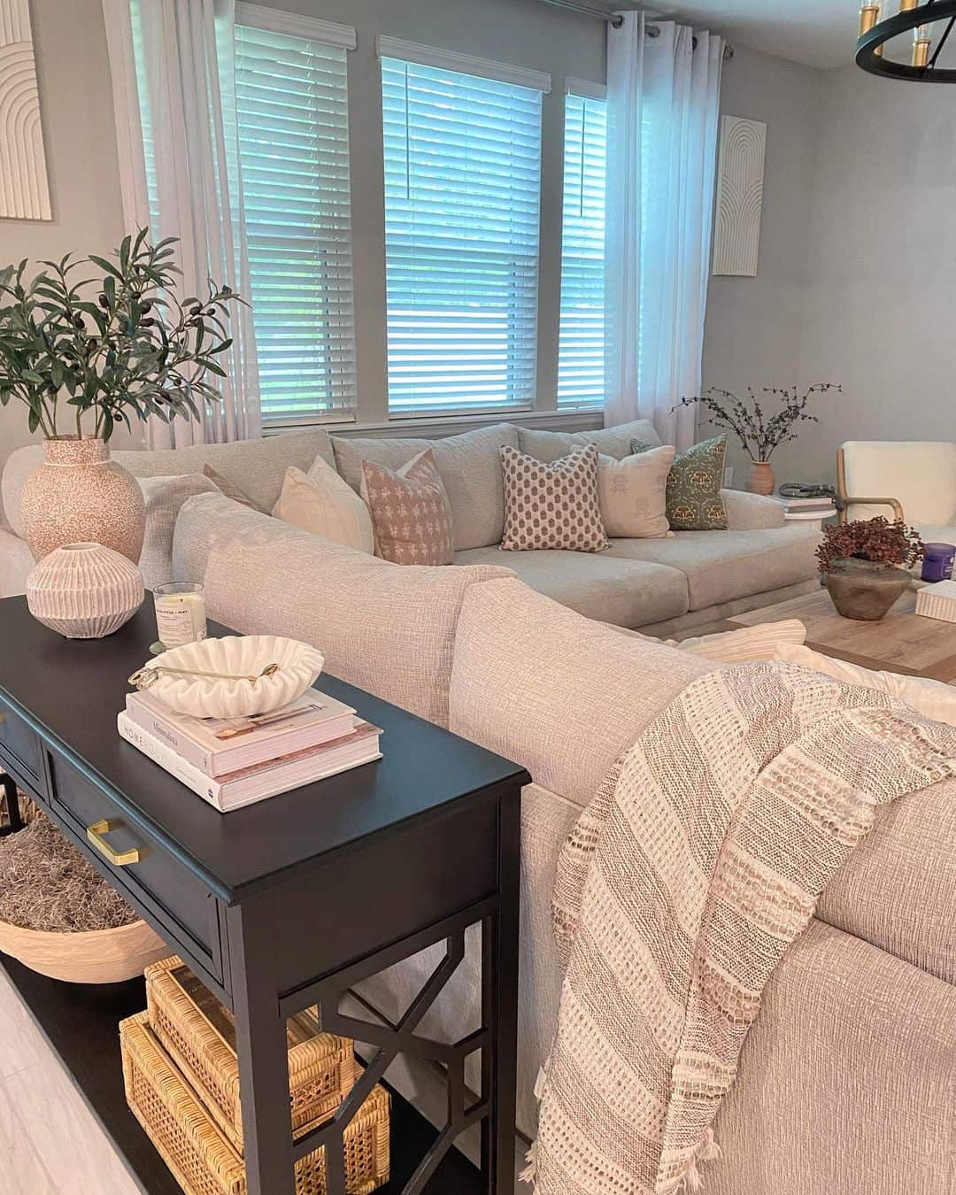 Contemporary Comfort: Striped Throw Blanket and Console Table Behind the Couch