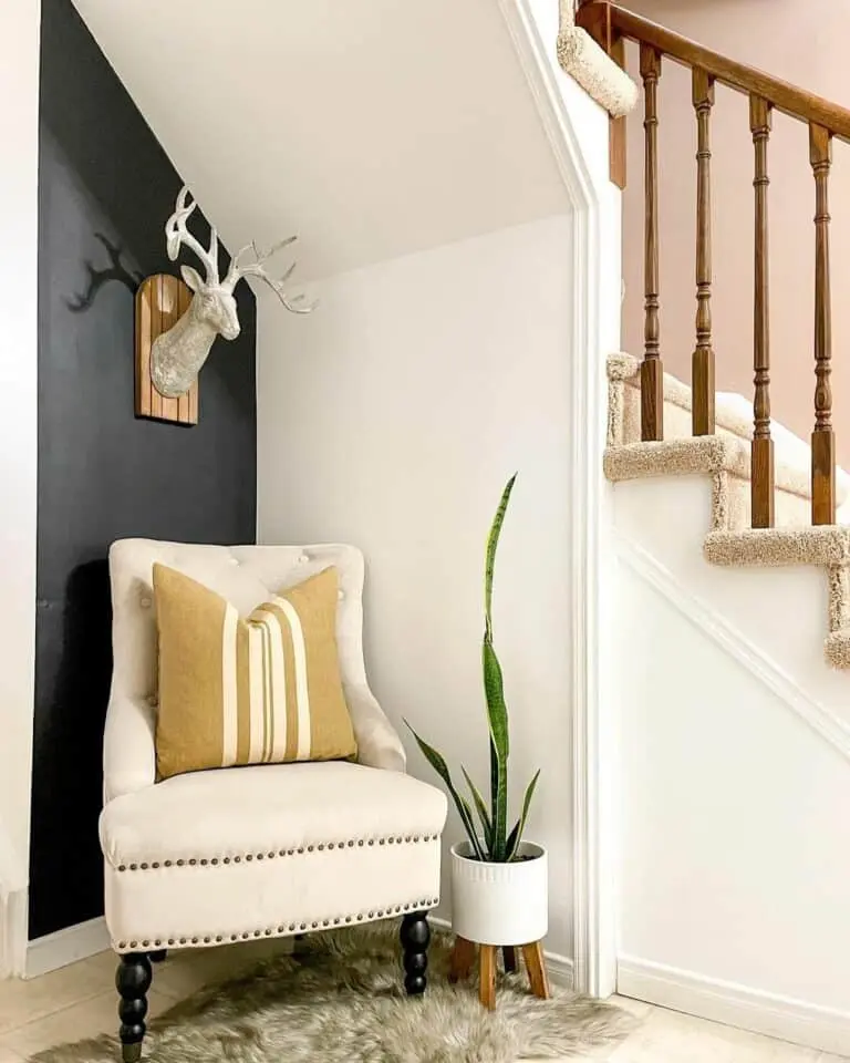 Elegant Entryway: Black Foyer Accent Wall and a Cozy Corner Chair