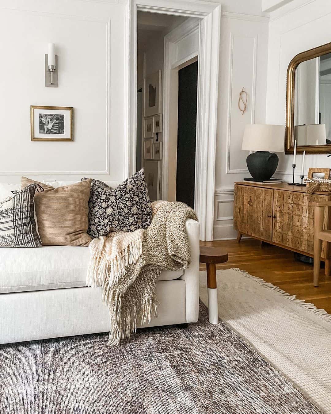 Rustic Elegance with Layered Rugs and a Wooden Sideboard