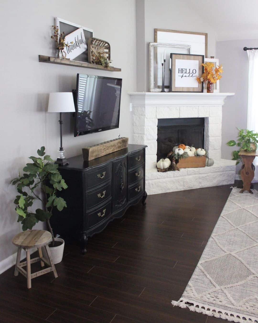 A Minimalist Living Room with Jet Black Console Table and White Fireplace