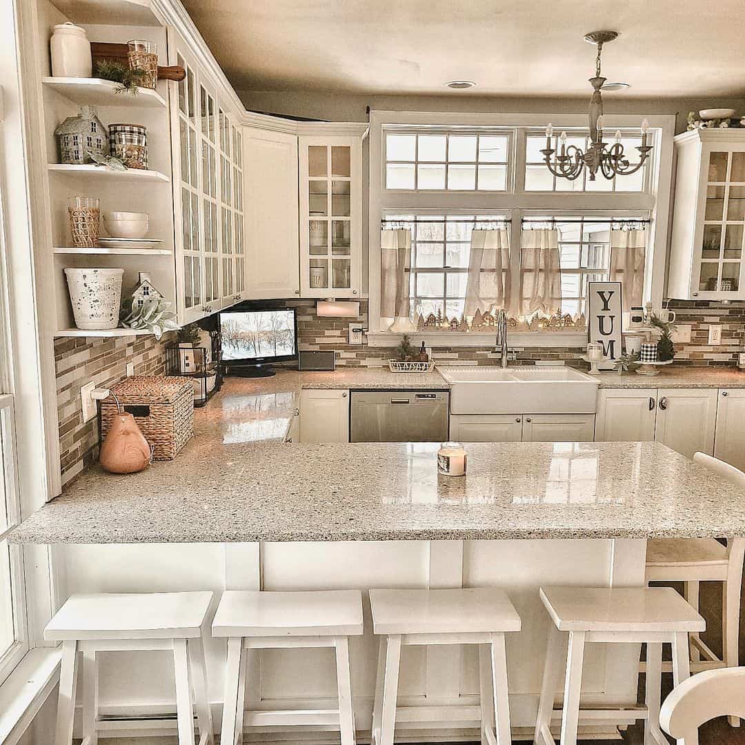 A White Kitchen Peninsula with Timeless Gray Countertop