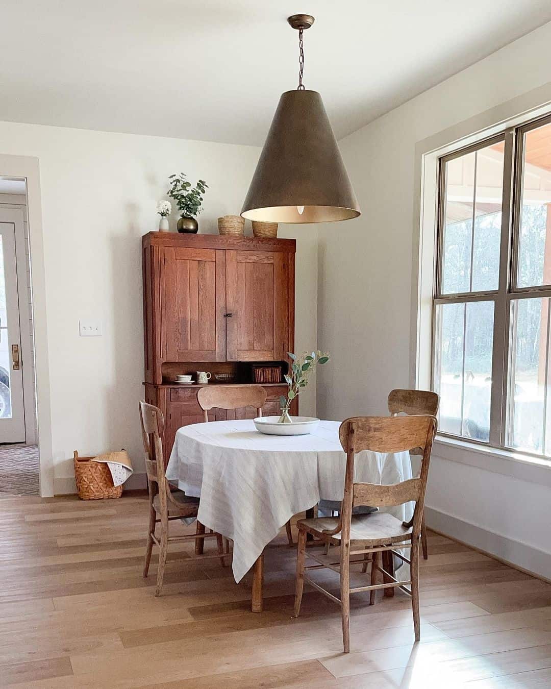 Grand Bronze Pendant Light Above Rustic Dining Table