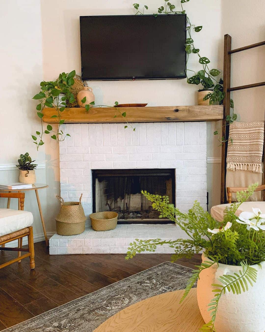 Infusing Green Vibes into Your Living Room with a White Fireplace