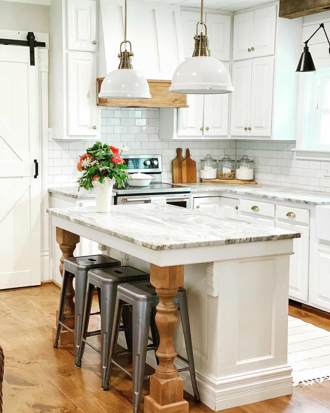 Radiant White Kitchen Island Illuminated by Pendants