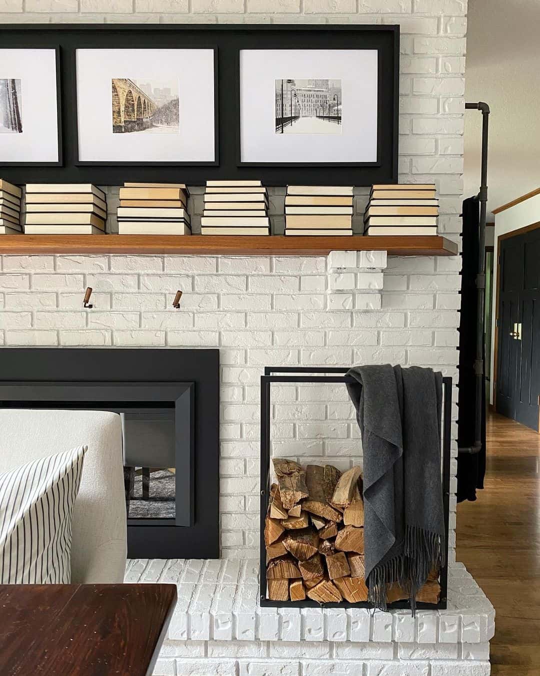 White Brick Fireplace Enhanced by a Black Photo Display