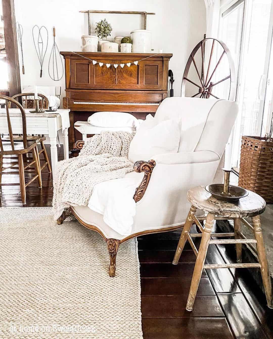 White Corner Chair Placed on Dark Wood Flooring