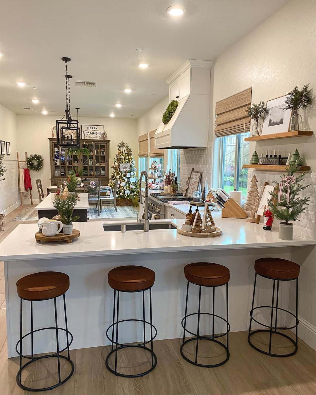 White Kitchen Peninsula Complemented by Brown Leather Stools