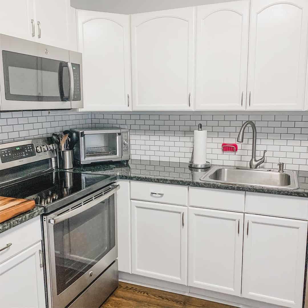 Elevating Farmhouse Charm with Wood Flooring and Subway Tile Backsplash