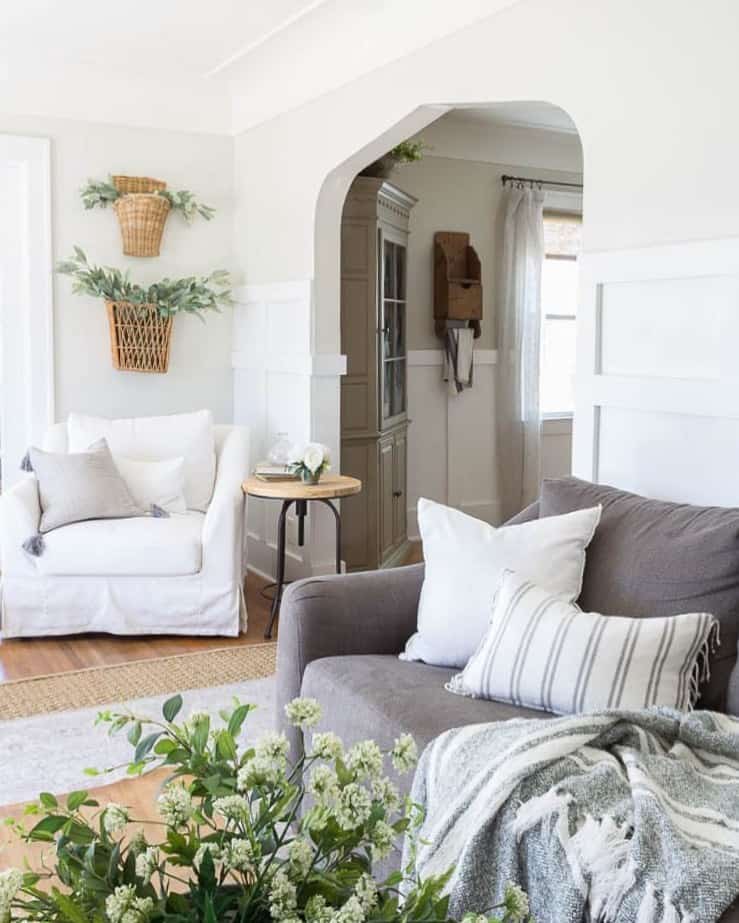 Farmhouse Living Room Elegance with Wicker Wall Decor and Greenery