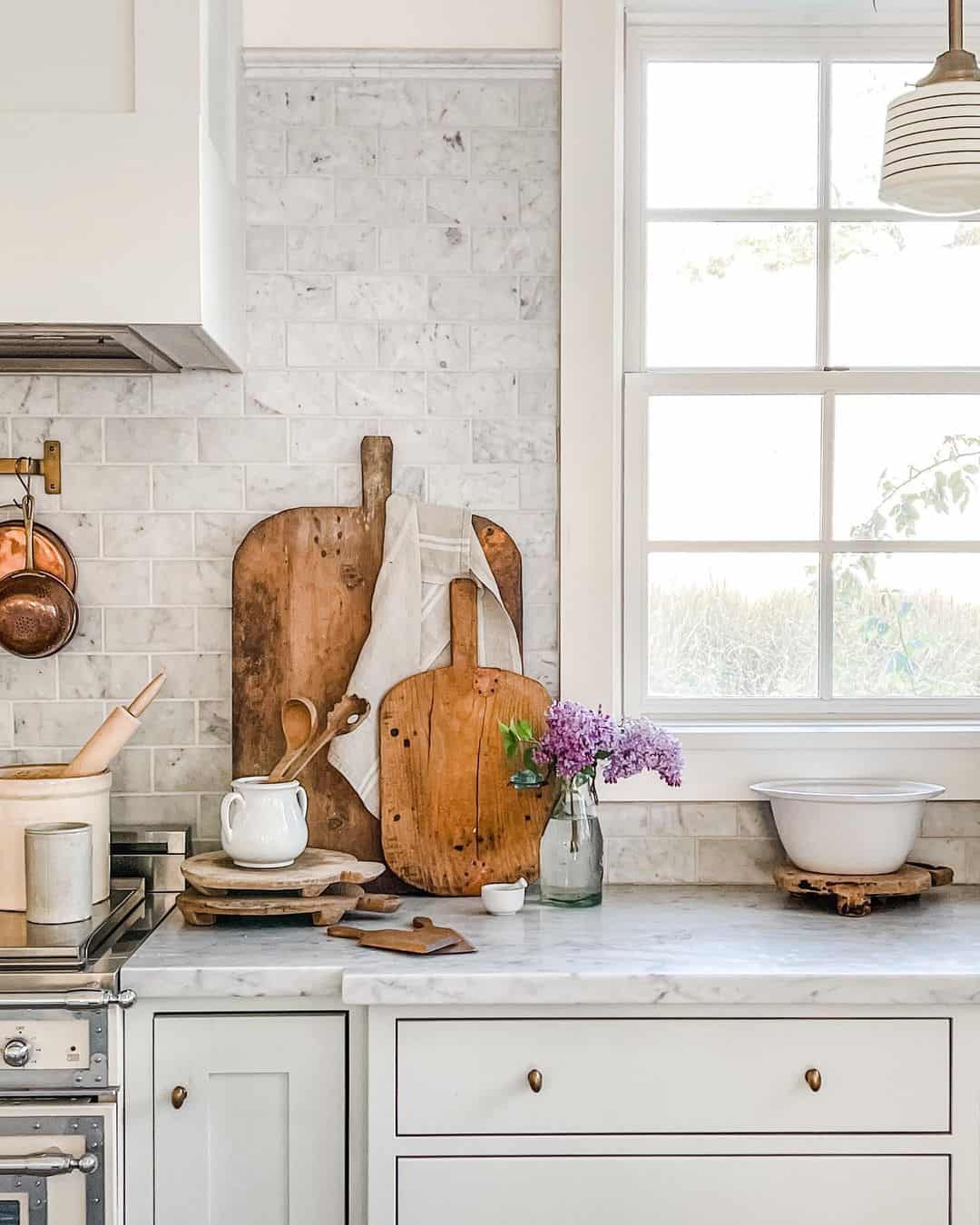 Rustic Elegance with a Marbled Backsplash Surrounding a White-Trimmed Window