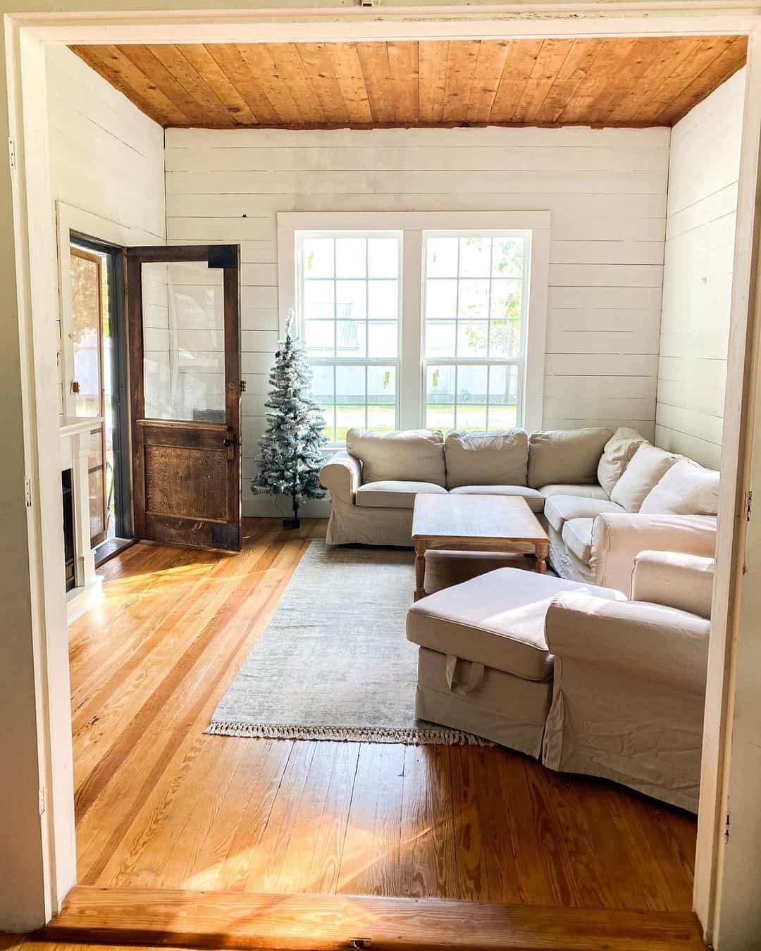 Farmhouse Style Living Area Featuring Shiplap Walls