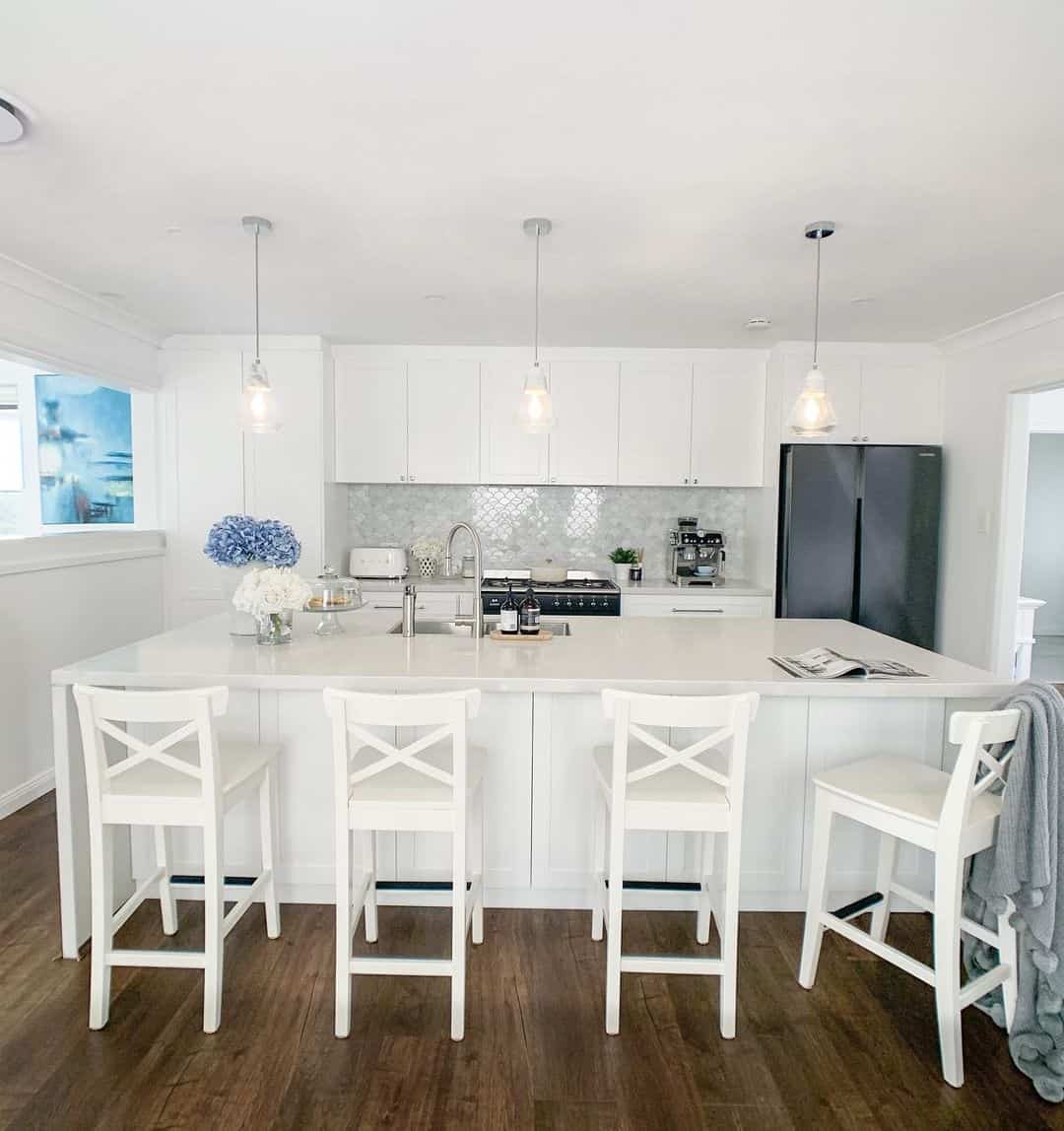 Minimalist Style in a White Kitchen with Bar Stool Seating