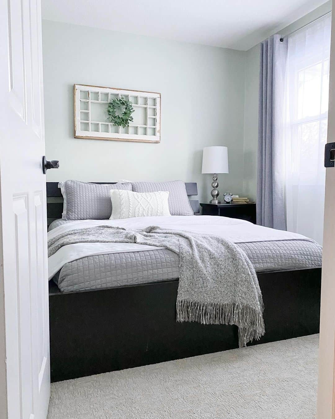 Stylish Black Platform Bed Harmonized with Subdued Gray Bedding