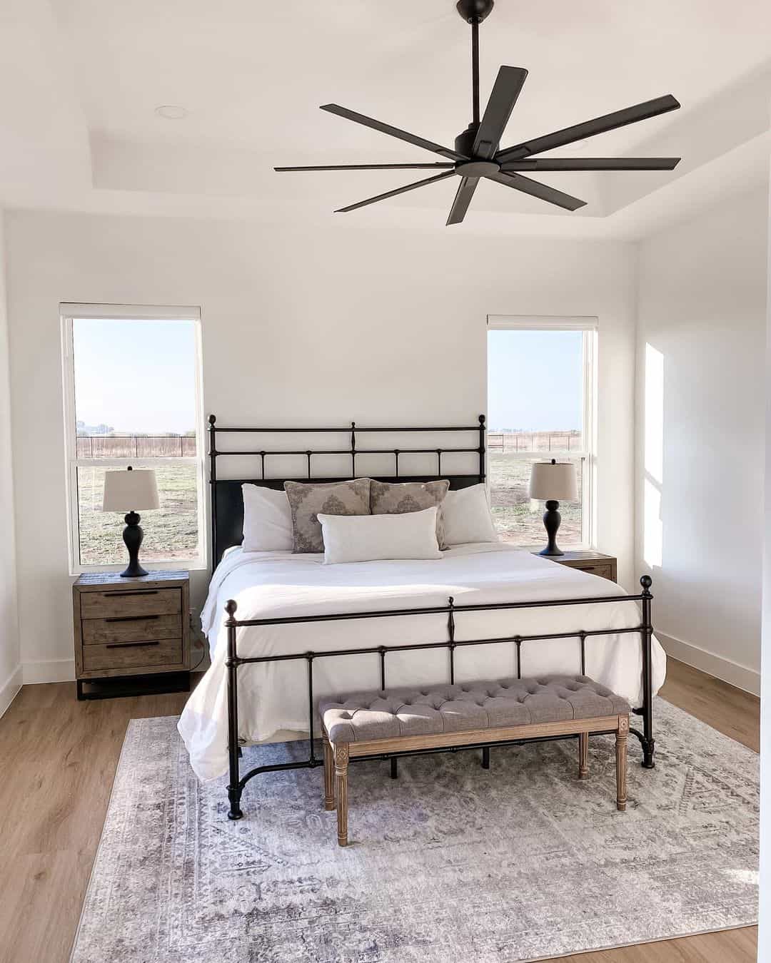 Tranquil White Bedroom with Sleek Black Ceiling Fan