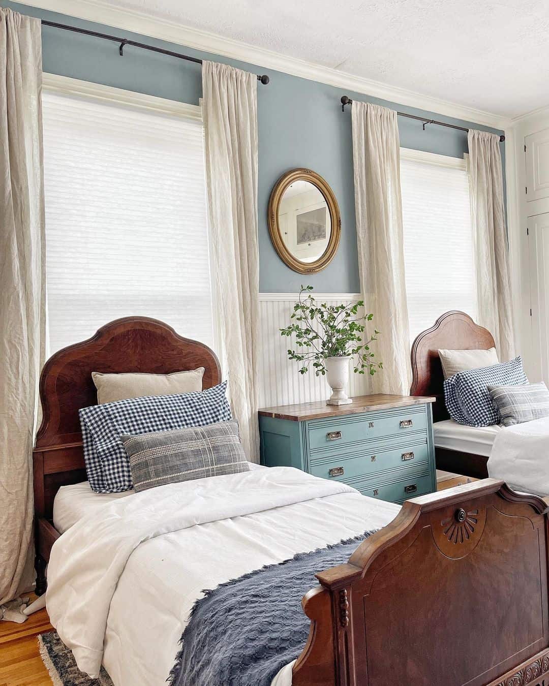 Twin Beds in Light Blue Bedroom with Oak Accents