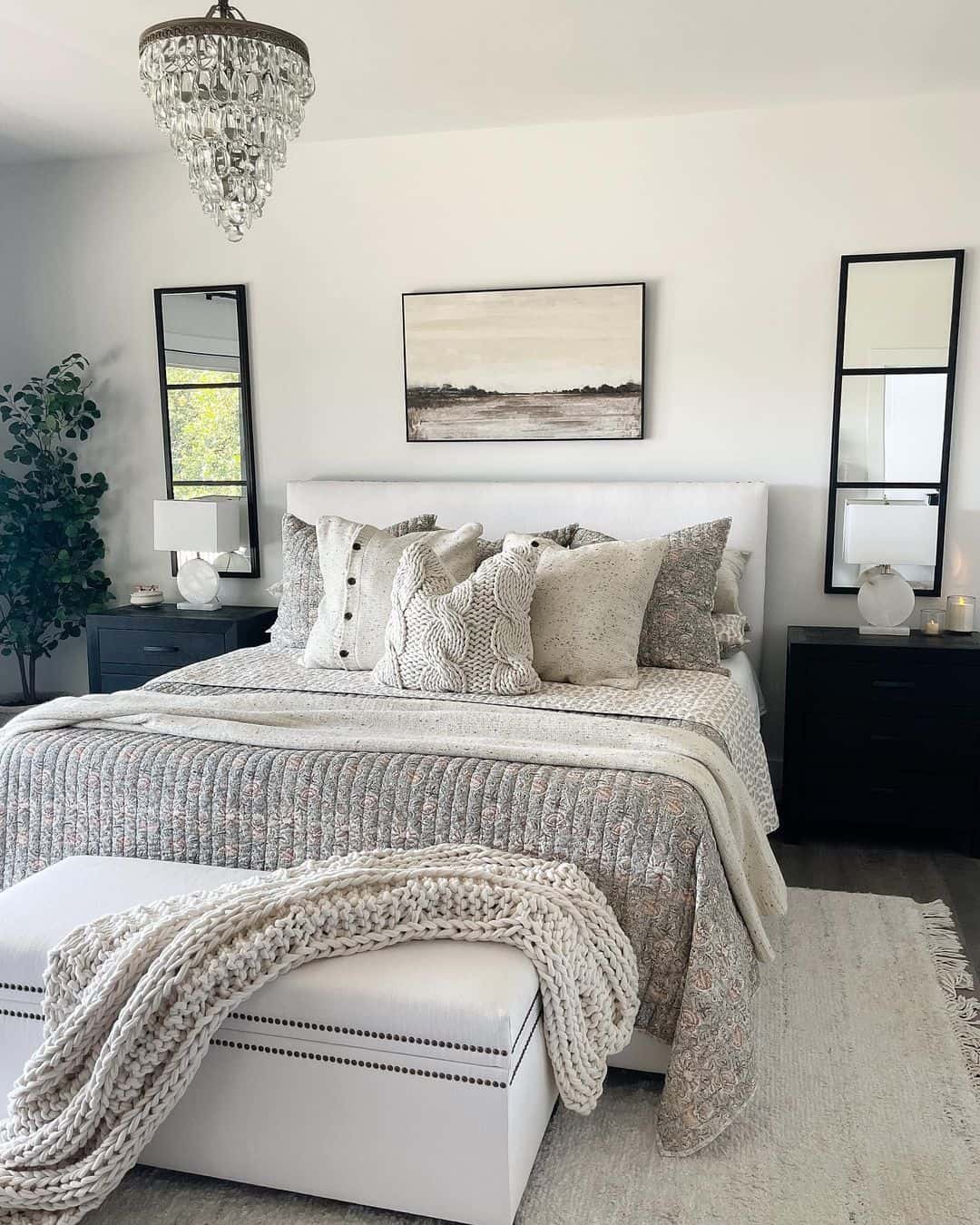 Chic White and Black Bedroom Featuring a Gray Floral Bedspread