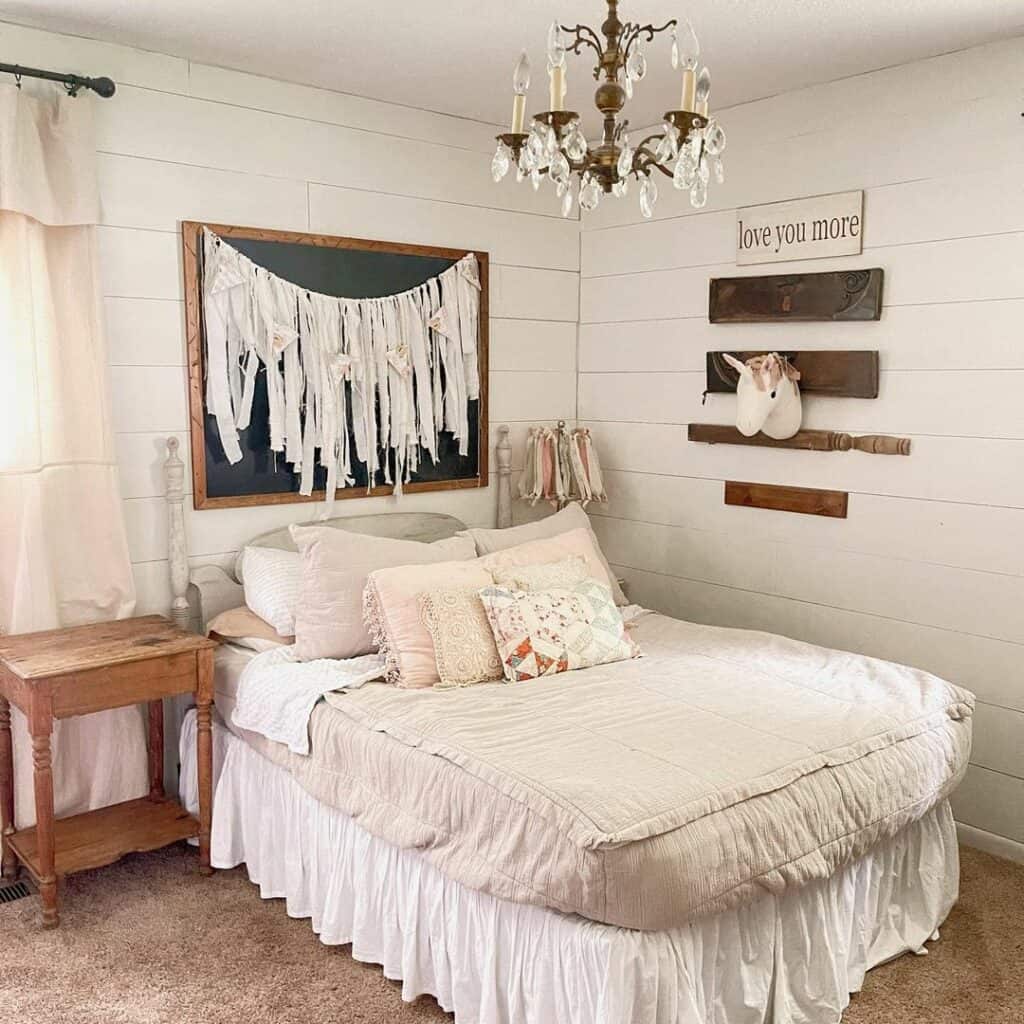 Charming Farmhouse Bedroom Embellished with a Vintage Chandelier