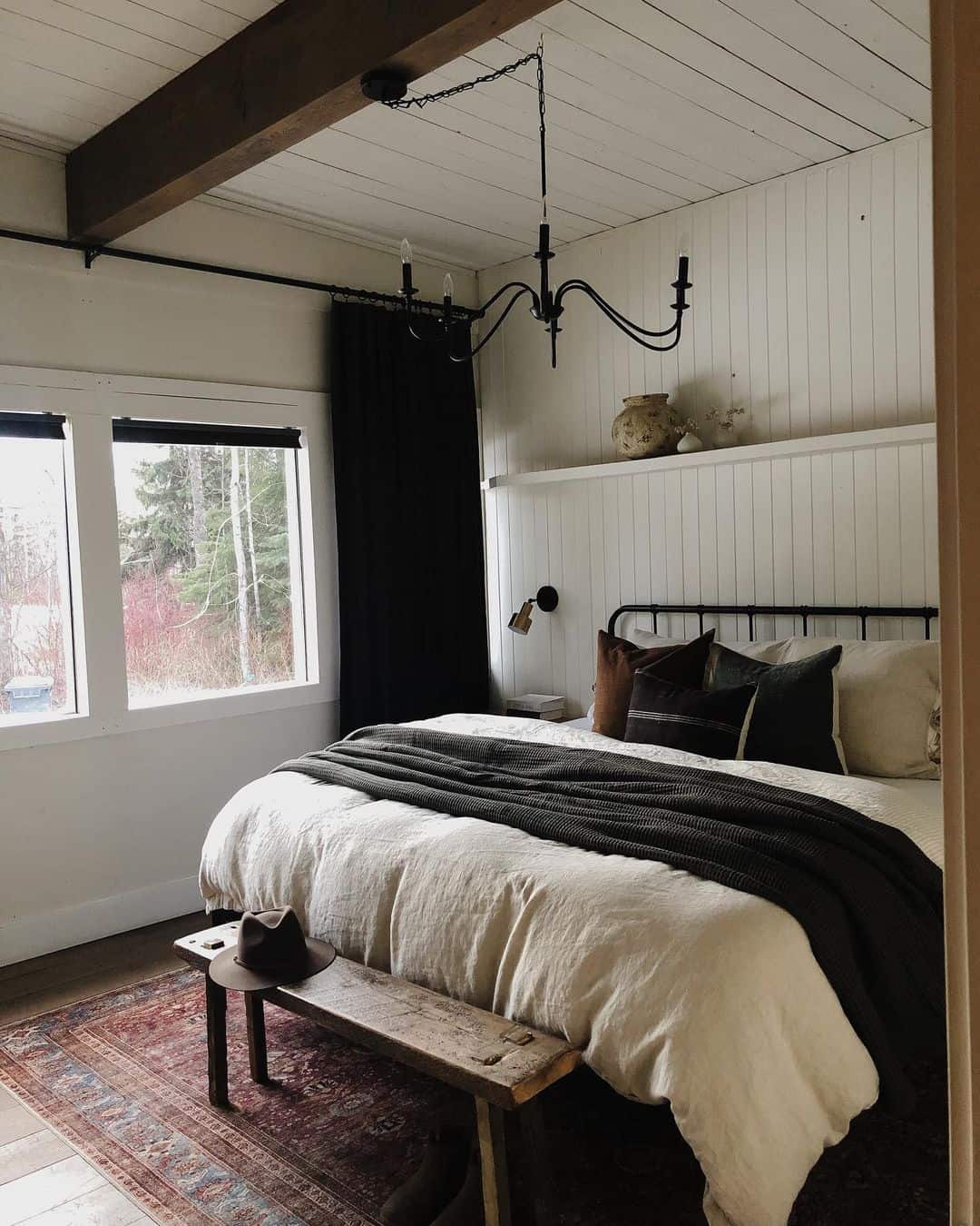 Farmhouse Bedroom Bathed in Black Chandelier Light