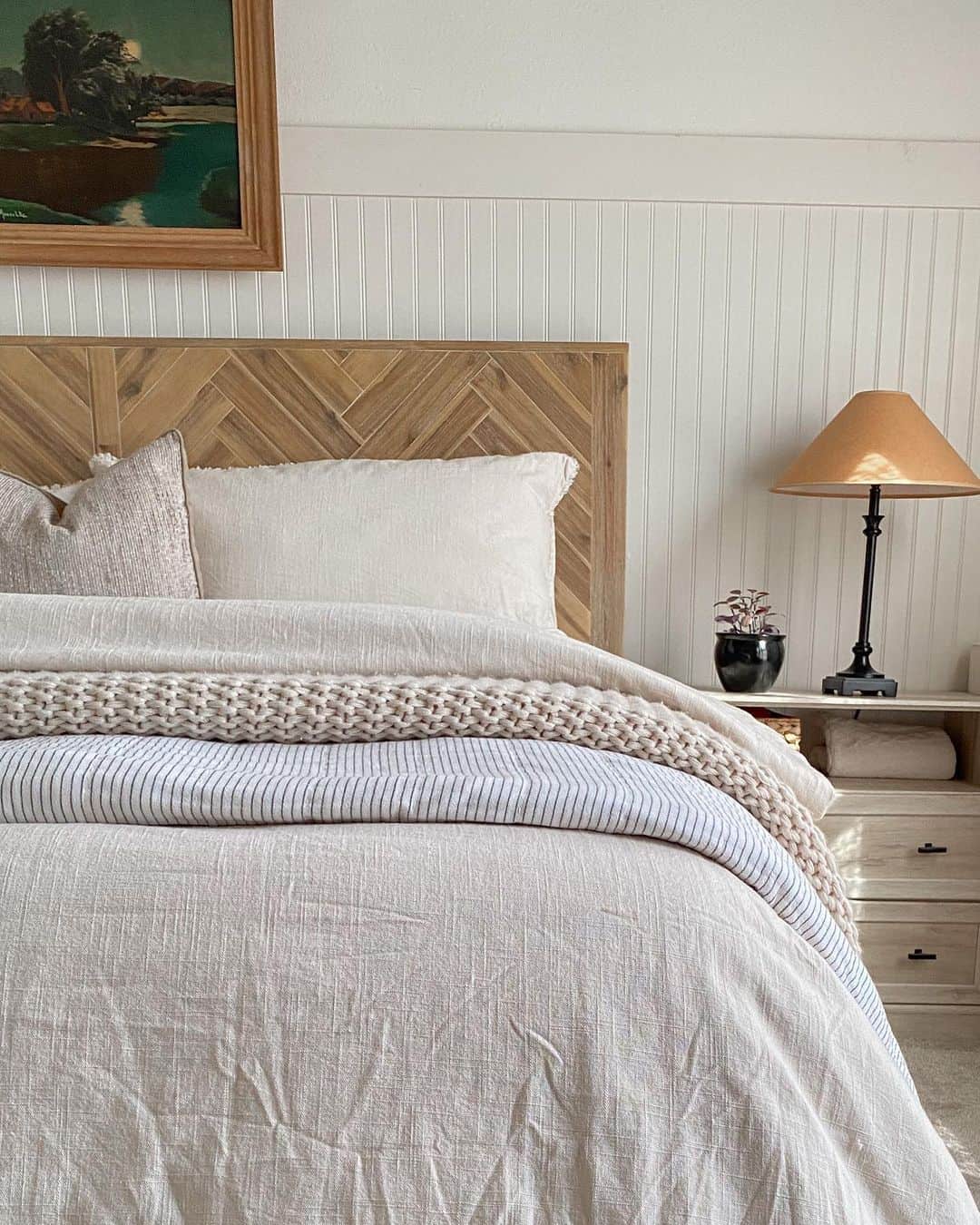 Quaint Bedroom Setting with Off-white Beadboard Wall