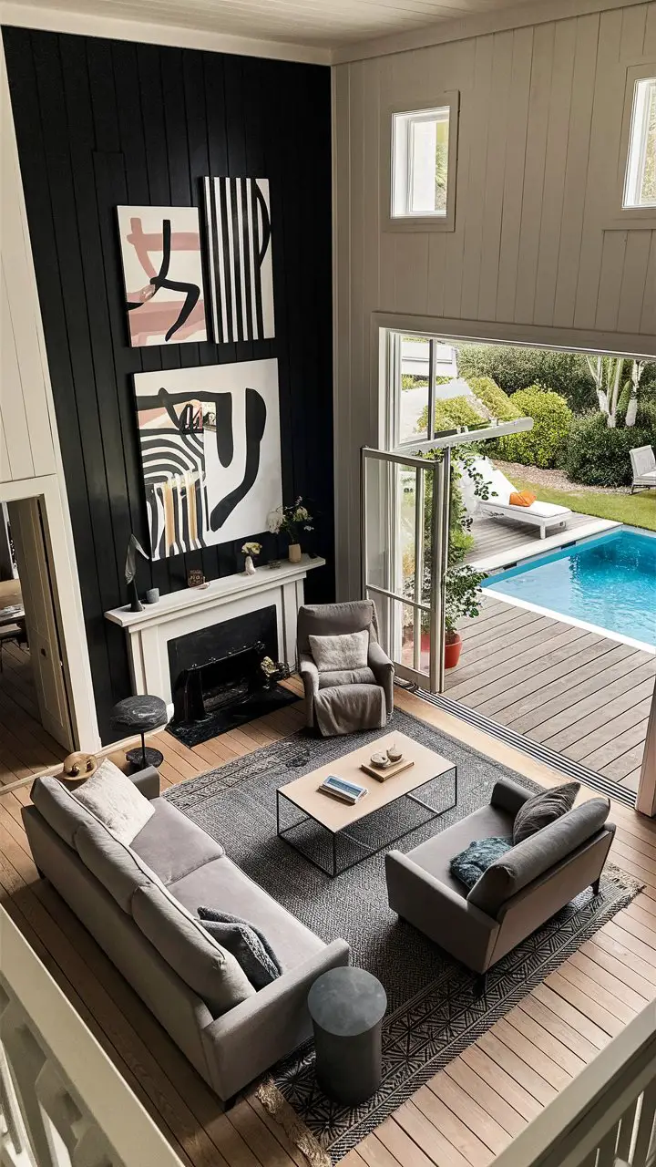 Scandinavian minimalist furniture complements a striking black accent wall adorned with modern art in this stunning living room, offering views of an outdoor pool and lush greenery.