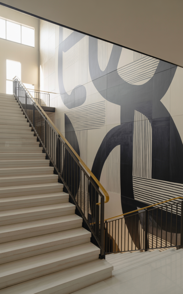 Create a monochrome mural along the staircase