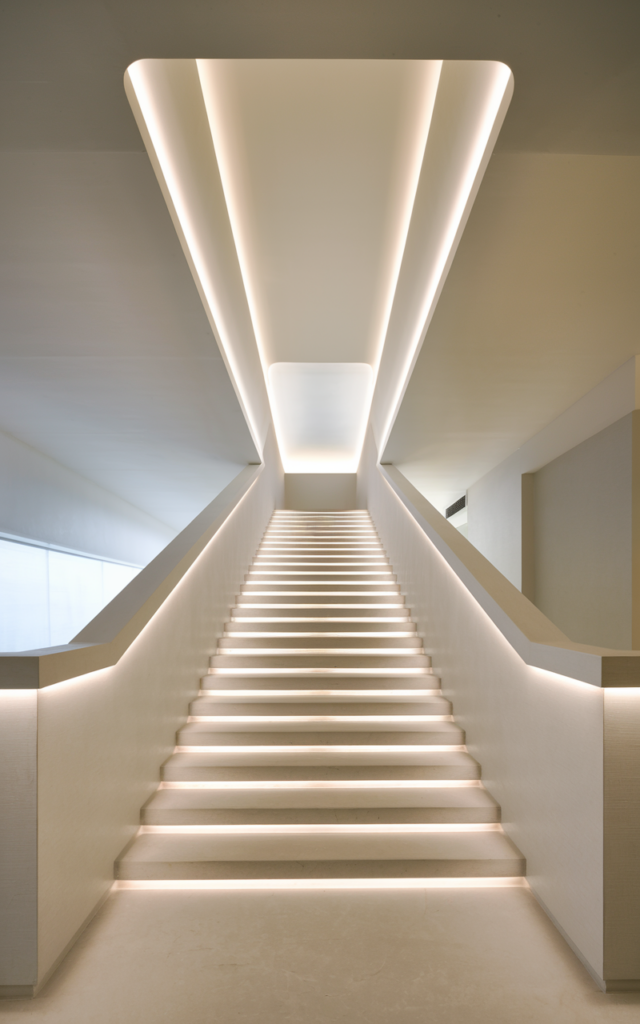 Highlight the stair ceiling with indirect cove lighting.
