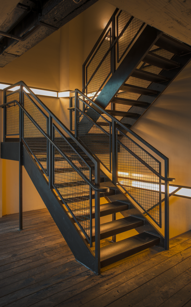 Mix matte black metal with industrial mesh panels.