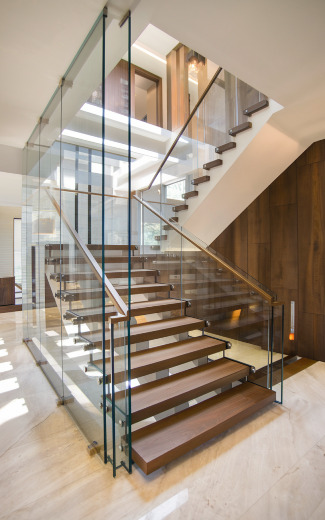 Wrap the staircase in frameless glass panels