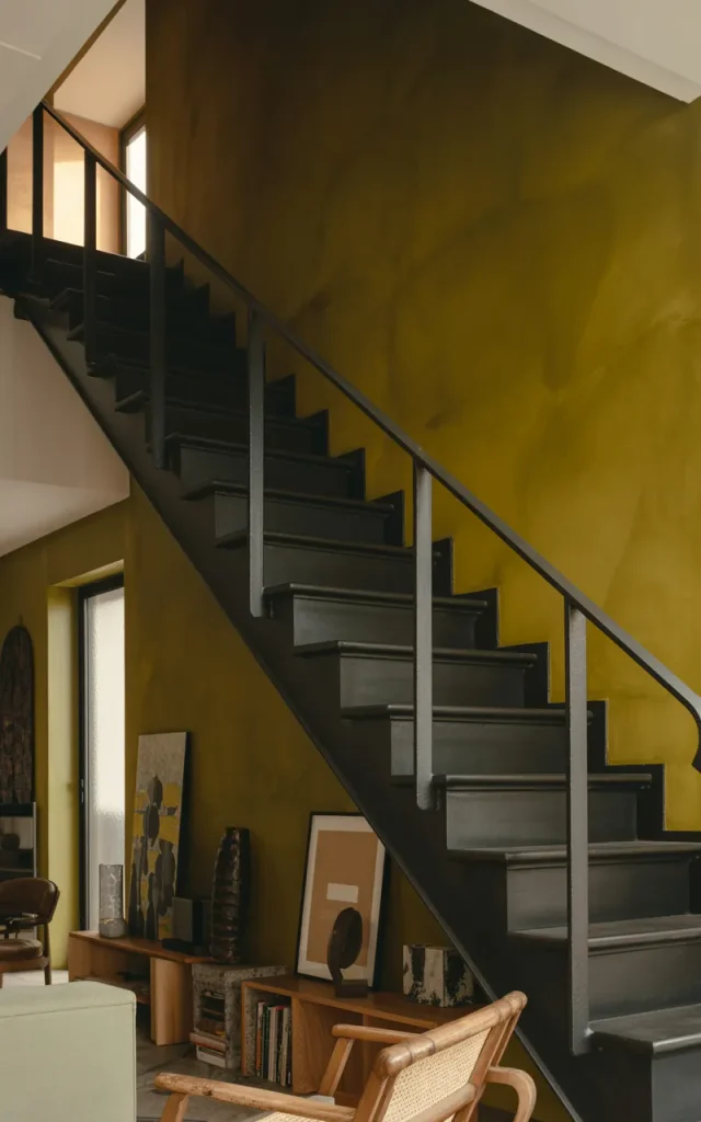 Combine black steel with bold accent walls