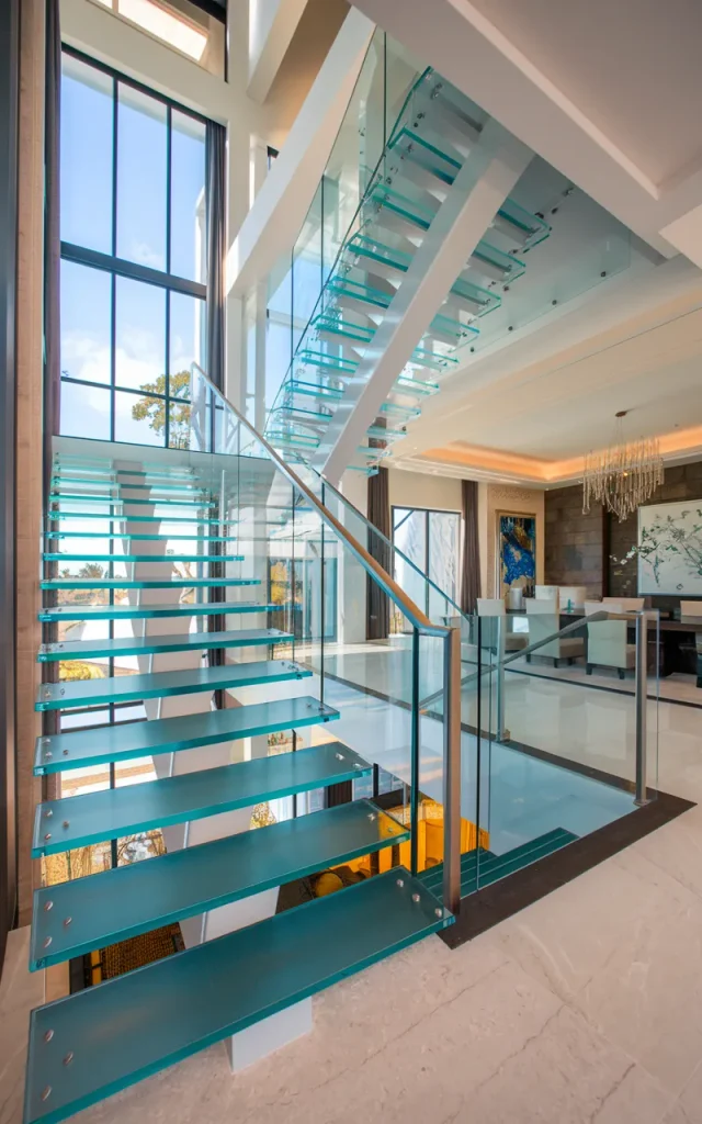 Build a double-height glass staircase wall 🏢