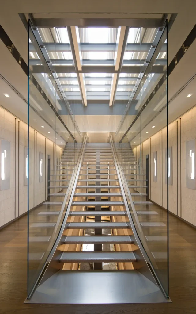 Combine steel stairs with glass side panels
