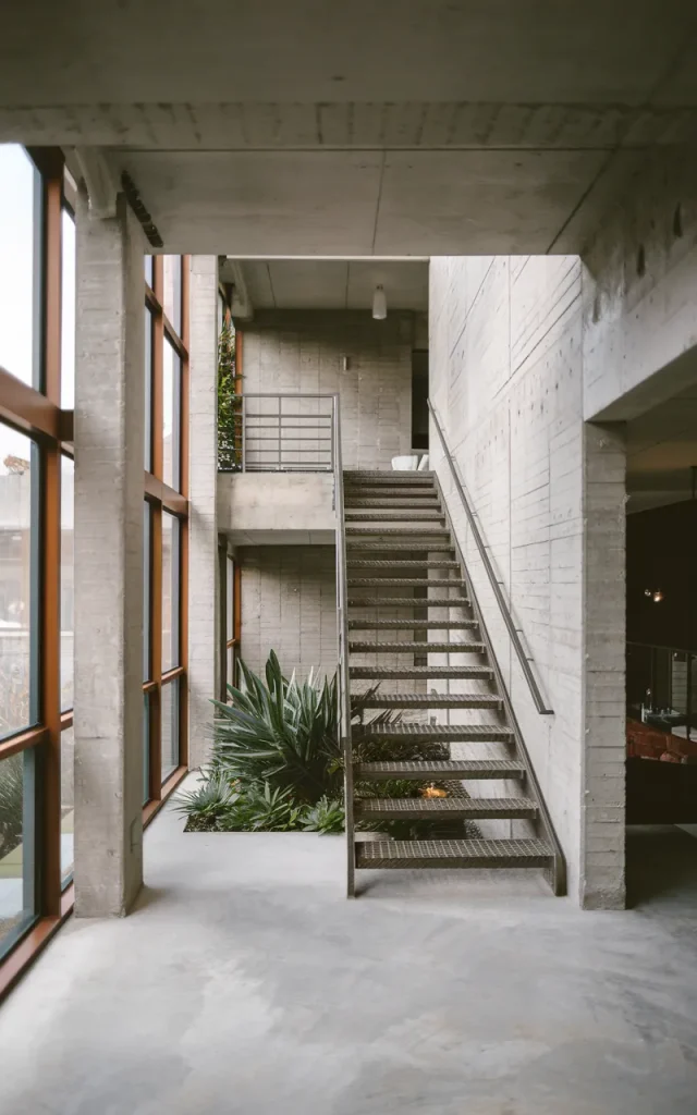 Pair steel stairs with textured concrete walls