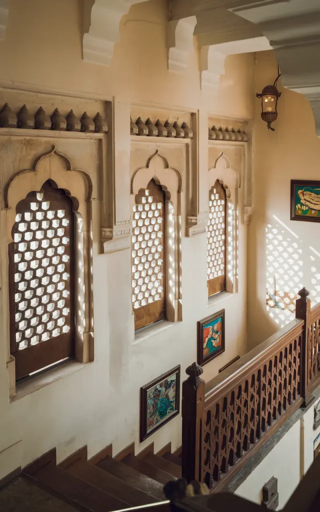 Use stone jharokha-style stair windows